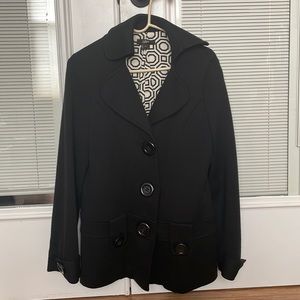 Fully lined jacket with statement buttons.